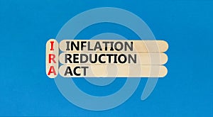 IRA inflation reduction act symbol. Concept words IRA inflation reduction act on wooden sticks on beautiful blue table blue photo
