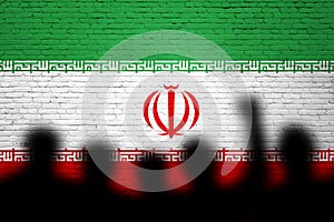 Iran flag painted on the brick wall with people