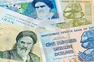 Iran Rial and Zimbabwe  hyperinflation Dollar banknotes. photo