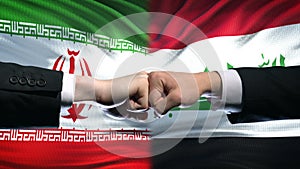 Iran vs Iraq conflict, international relations crisis, fists on flag background