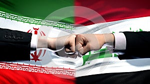 Iran vs Iraq conflict, international relations crisis, fists on flag background