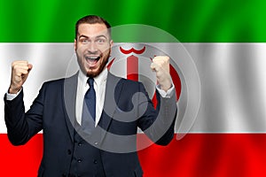 Irani happy businessman on the background of flag of Iran Business, education, degree and citizenship concept photo