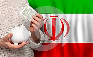 Irani woman with money bank on the background of Iran flag. Dotations, pension fund, poverty, wealth, retirement concept