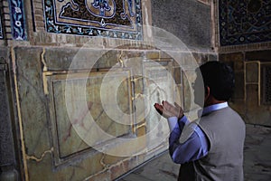 Iranian man praying inside Jameh Mosque of Isfahan city in Iran.