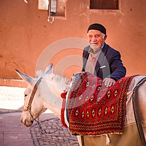 Iranian man and white pony