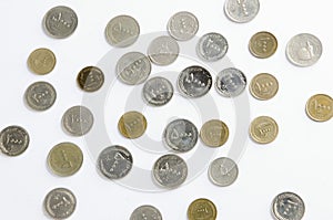 Iranian Rial Coins Scattered on White Background