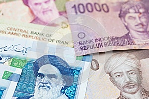 Iranian Rial and Indonesian money Rupiah banknotes.