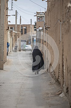 iranian woman in a streets of an old village in Iran