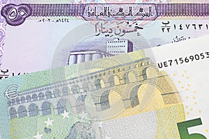 Iraqi currency with a five Euro note