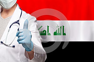 Iraqi doctor's hand showing thumb up positive gesture on flag of Iraq background