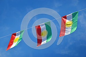 Iraqi Kurdish flag, three side by side in the blue sky