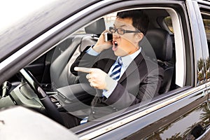 Irate businessman talking with cell phone