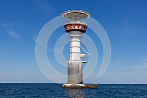 Irbe lighthouse in Baltic sea photo