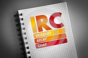IRC - Internet Relay Chat acronym on notepad, technology concept background