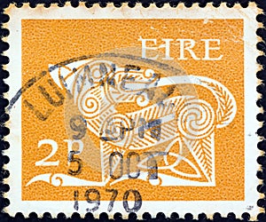 IRELAND - CIRCA 1971: A stamp printed in Ireland shows a dog from an ancient artwork, circa 1971.