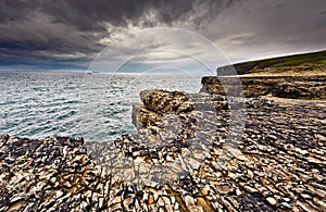 Ireland, cliffs under dramatic sky, Loop Head