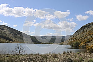 Ireland landscape with a lake, mountains and clouds.