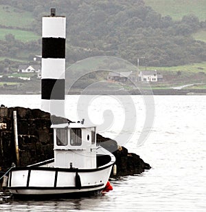 Ireland- Misty Scenic View of Black and White Boat and Light