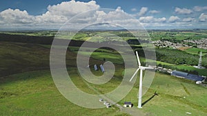 Ireland wind turbine spin aerial view: solar panels on green valley. Beautiful Ballycastle landscape