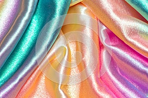 Iridescent fabric background. Shiny mother of pearl fabric, bright multi-colored fabric