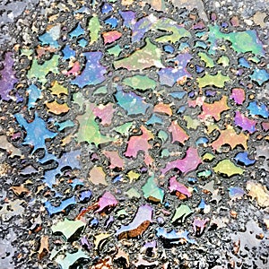 Iridescent overflows of petrol spots on the surface of the water on the asphalt. photo