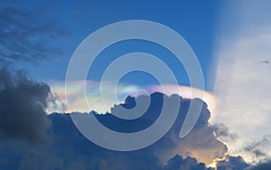 Iridescent pileus cloud or rainbow sky with white fluffy clouds at sunset in the evening. Abstract nature landscape background