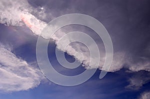 Irisation and clouds in blue sky