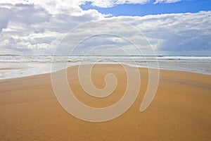 Irish beach with sand and cloudy sky Ireland photo