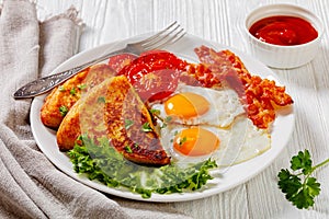 Irish breakfast of fried eggs, bacon, potato farls