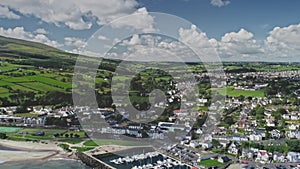 Irish coastal cityscape aerial view: pier Ballycastle, Co Antrim. Yachts, ships on ocean bay waters