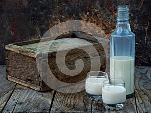 Irish coffee cream liqueur Baileys in glass and botle on wooden background