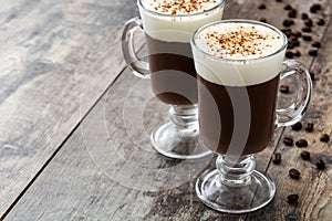 Irish coffee in glass on wood