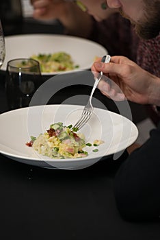 Irish colcannon served in a white bowl or traditional mashed potato with addition of kale, leek and green onion, close-up