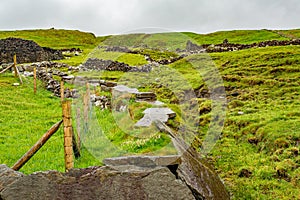 Irish countryside with ruins of a house and stone fences