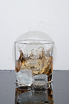 Irish drink, Bourbon or Scotch. Advertising glasses in a freeze frame with ice