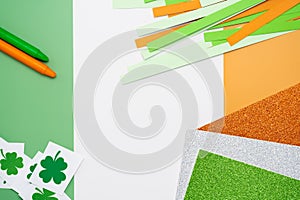 Irish flag made from color paper with cut out shamrock clover crayons and glitter paper