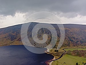 Dark clouds over Guiness lake in wicklow mountains photo