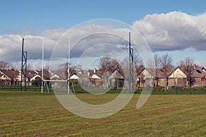 Irish National sport goal post on a training ground. Camogie, hurling, rugby, gaelic football pitch. Warm sunny day, Cloudy sky.