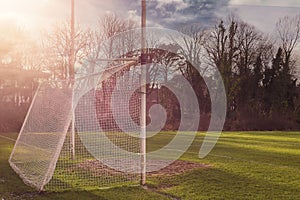 Irish National sport goal posts on a green grass training pitch.