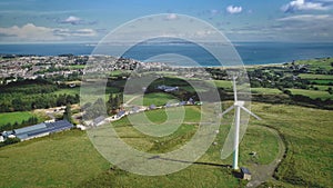 Irish port town windmill aerial view: solar station, Ballycastle pier, Atlantic ocean bay at summer