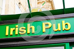 Irish pub sign text on bar entrance in city europe street storefront facade building