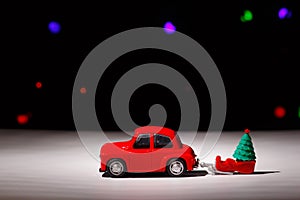 Irkutsk, Russia - November 28, 2020: Christmas red car carrying a sleigh with a christmas tree on christmas eve