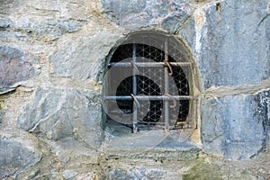 Iron barred window of an old fortress..