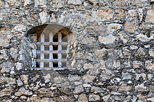 Iron bars in medieval castle window and stone old wall of a medieval An Felipe castle construction in Guatemala. Background