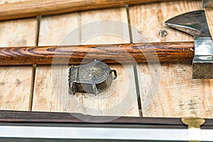 Iron battle ax and powderman on a wooden table close-up