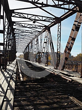 Iron black brutal structures of an inoperative automobile bridge requiring restoration and repair in the city of Petrovsk in