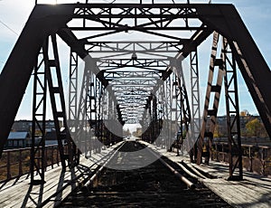 Iron black brutal structures of an inoperative automobile bridge requiring restoration and repair in the city of Petrovsk in