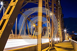 Iron bridge with car light trails