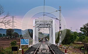 Iron bridge of Indian railways with electric polls. photo