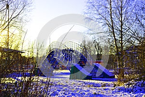 Iron bridge over icy lake in winter